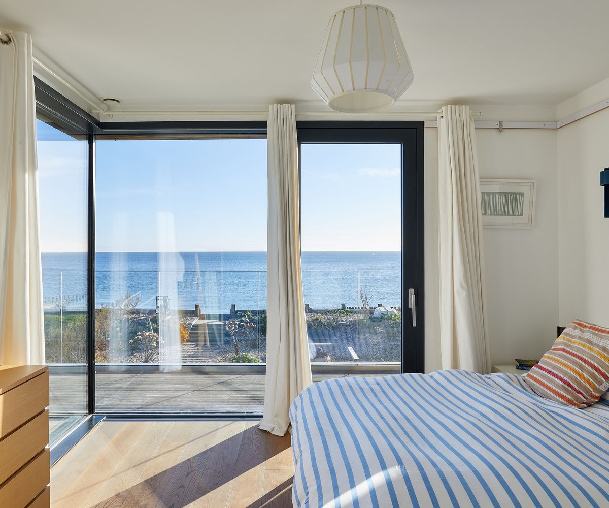 Double bedroom with sliding doors letting in lots of natural light and a sea view