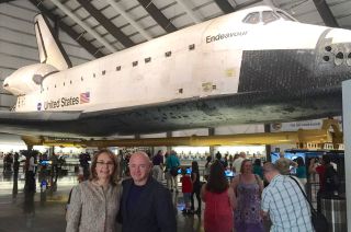 Former astronaut Mark Kelly and his wife Gabrielle Giffords pose for a photo with NASA's space shuttle Endeavour at the California Science Center in Los Angeles.