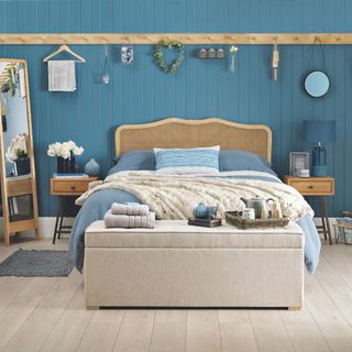 beach themed bedroom with wooden floor and mirror