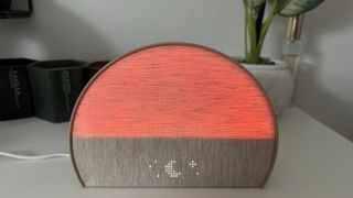 Hatch Restore 2 sunrise alarm clock lit up orange on night mode