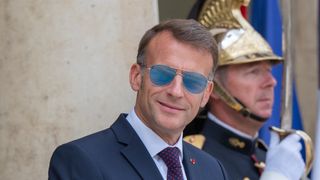 Emmanuel Macron, President of the French Republic, wearing sunglasses, is seen in a tight portrait on the steps of the Elysee Palace ahead of a meeting with Antonio Jose Seguro, in Paris, France, on July 1, 2026. (Photo by Henrique Campos / Hans Lucas / AFP via Getty Images)