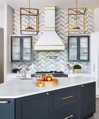 Blue and white kitchen with zigzag design backsplash around oven