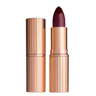 Charlotte Tilbury K.I.S.S.I.N.G lipstick in Night Crimson on a white background