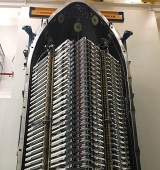 Sixty satellites for SpaceX's Starlink megaconstellation are stacked in their payload fairing ahead of a planned May 15, 2019, launch.