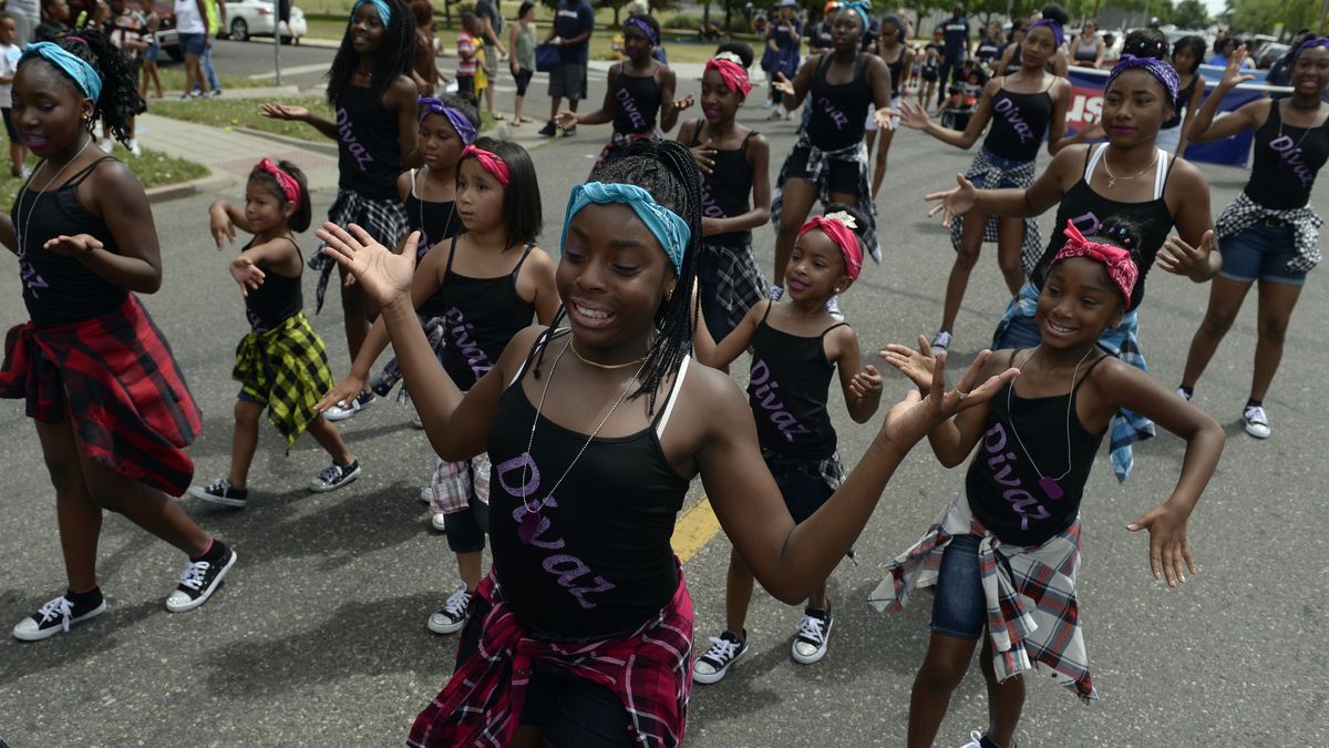 Members of Divaz dance group join participants in the Juneteenth Music Festival and parade on June 17, 2017 in Denver, Colorado. Organizers say that this is one of Denver&#039;s longest-running parades, dating back to the 1950s.