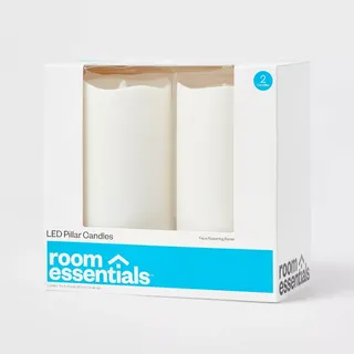 Two white plastic LED candles with fake flames in a white cardboard box