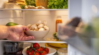 picture of man taking mushrooms out of fridge