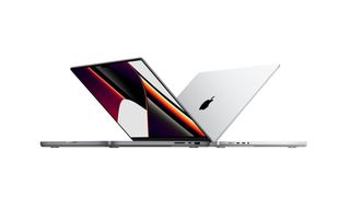 Two new Apple MacBook Pros sit back to back. 
