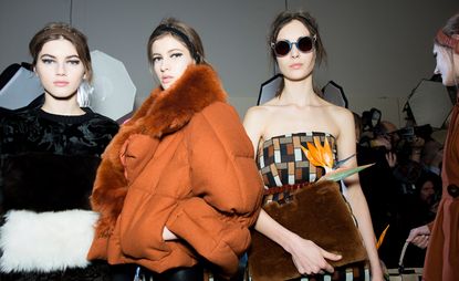 Female models wearing orange and orange, brown and black clothes from the Fendi A/W 2015 collection