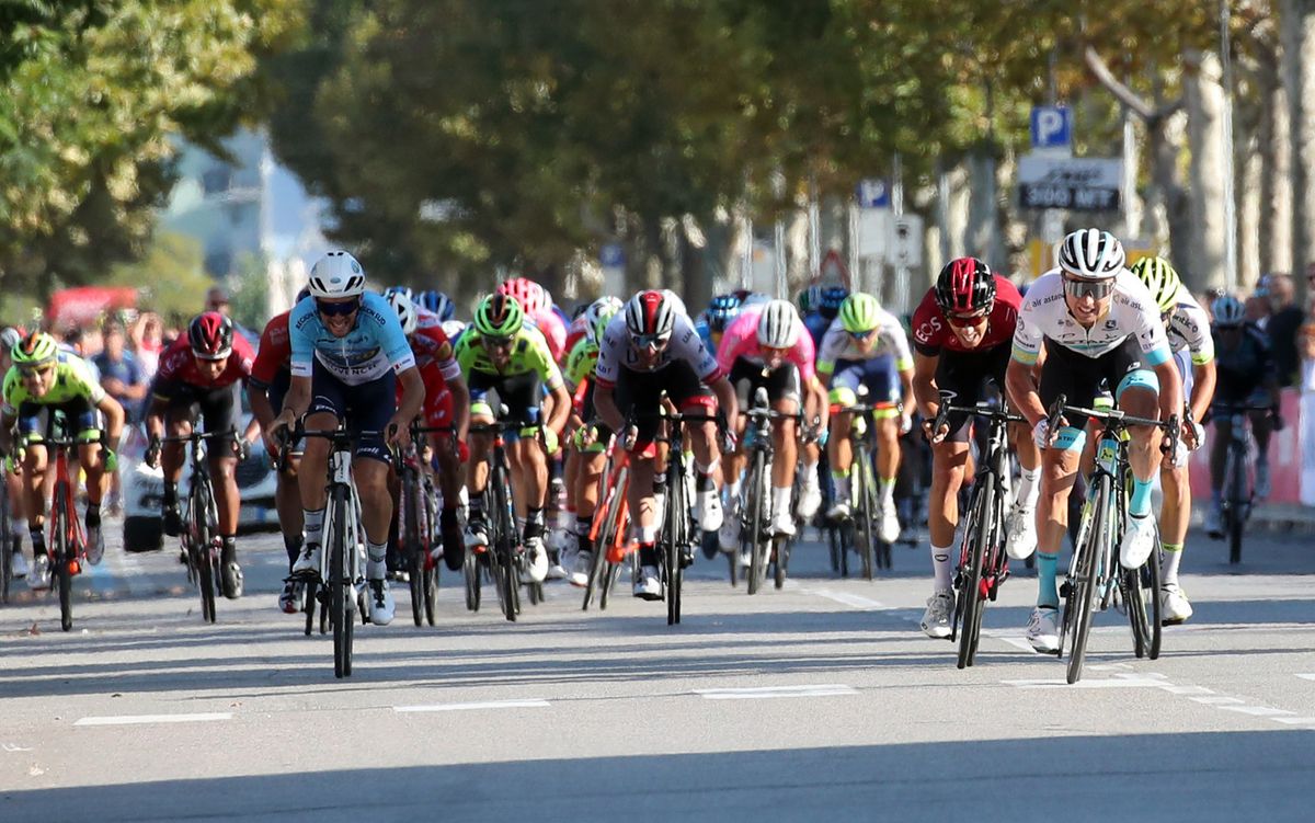 Lutsenko charges for the line just ahead of Rosa and the peloton
