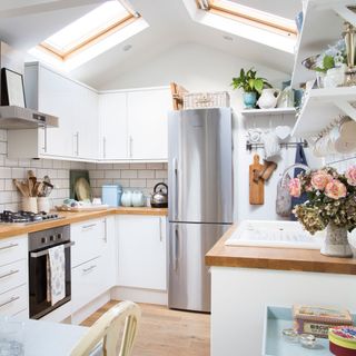 attic white kitchen with cabinets and worktop