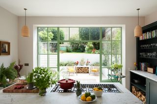green crittall-style doors in a classic kitchen