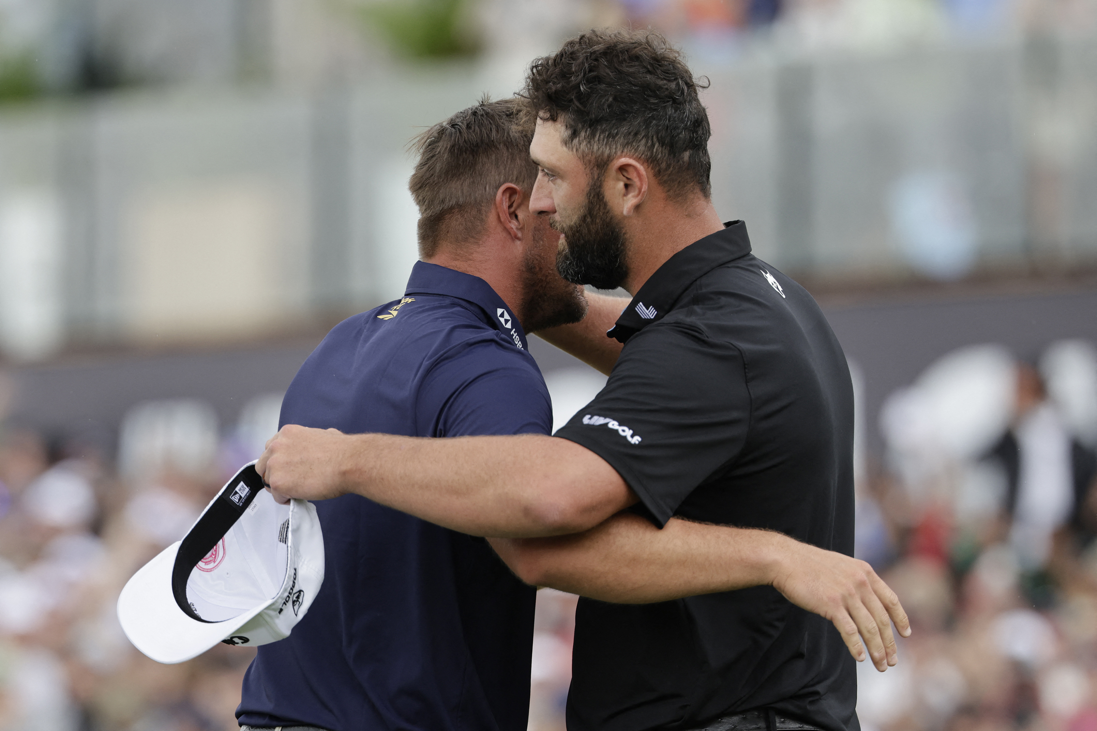 Legion XIII's Spanish player Jon Rahm (R) congratulates Crushers GC's US player Bryson Dechambeau (L) after winning the playoff and the LIV Golf South Africa tournament on the fourth day of the LIV Golf South Africa tournament at The Club in Steyn City on March 22, 2026. (Photo by WIKUS DE WET / AFP)