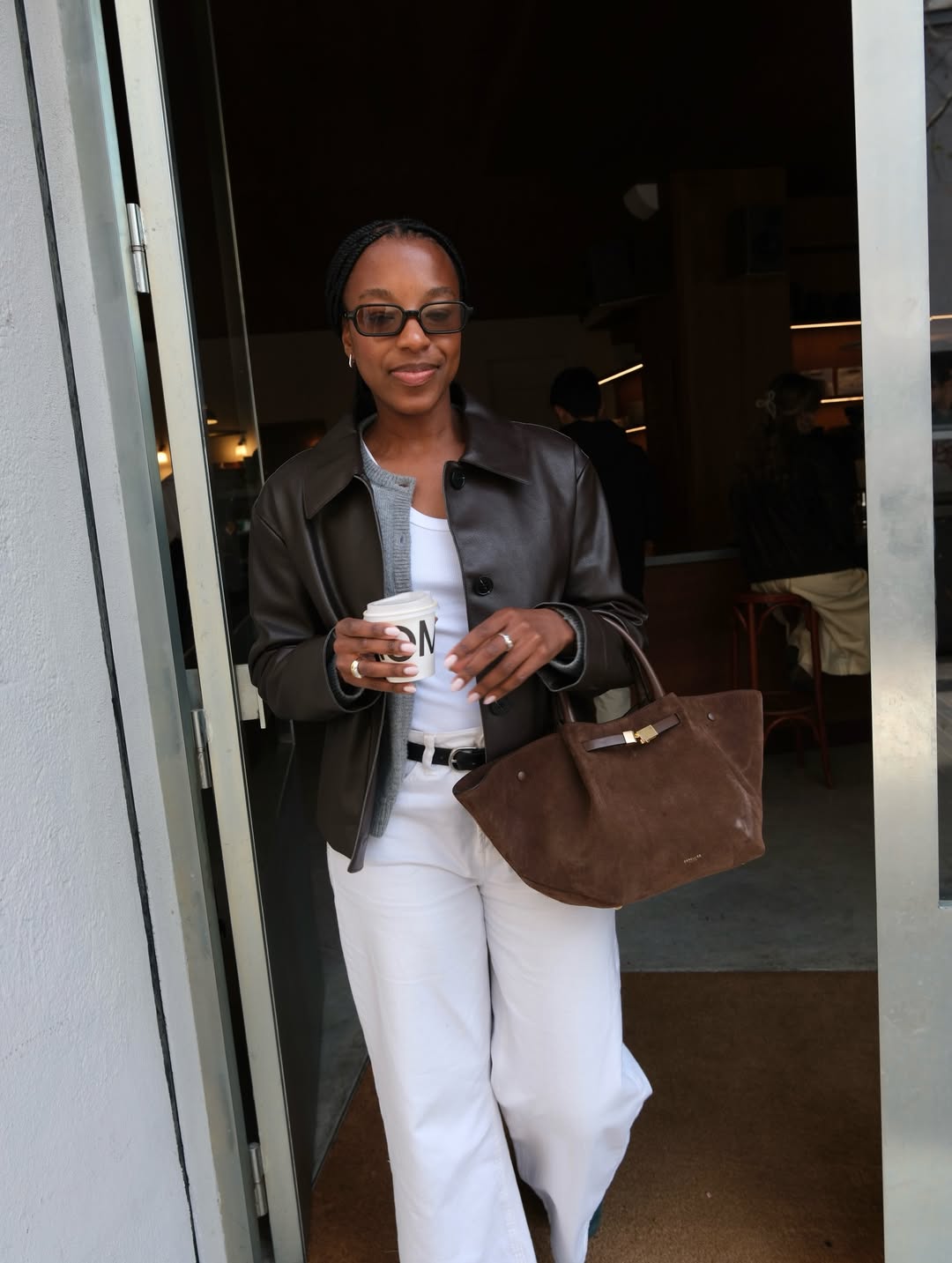 Taffy in minimalist sunglasses and leather jacket