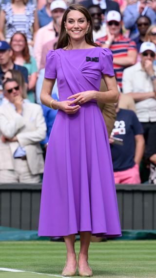 Catherine, Princess of Wales stands on court ready to present the trophy to the winner of the Wimbledon 2024 Men's Final