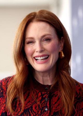 Actress Julianne Moore wears a red and black buttoned up cardigan