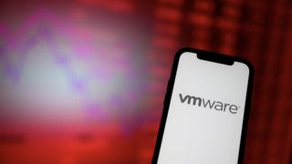 Phone showing VMware logo with in front of a red background
