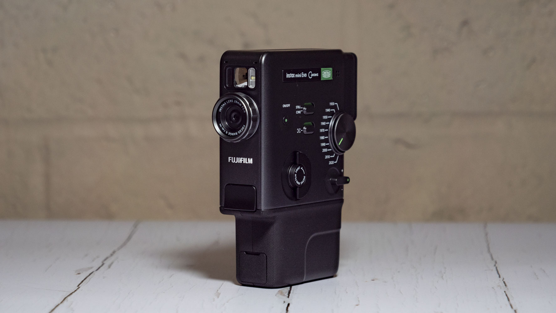 Fujifilm Instax Mini Evo Cinema on a white wooden surface