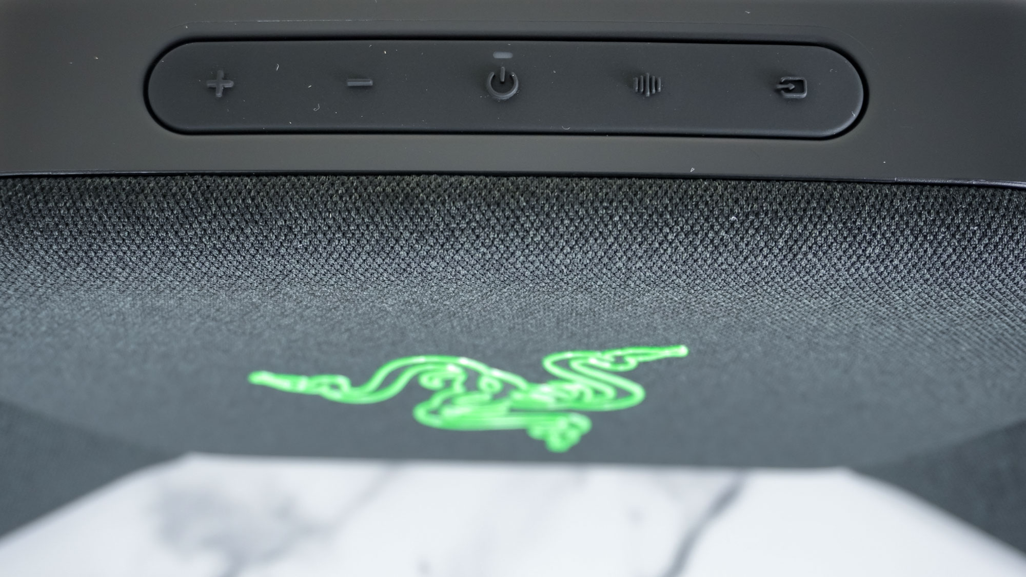 A closeup shot of the control buttons on top of the Razer Clio wireless speaker head cushion