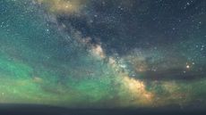 Weekly horoscope: The Summer Milky Way stretches across the night sky above Atlantic coastline. Long exposure with drone light painting.