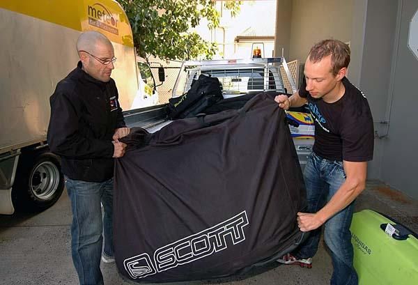 Jure Robic and Matej Mugerli unpack their bikes.