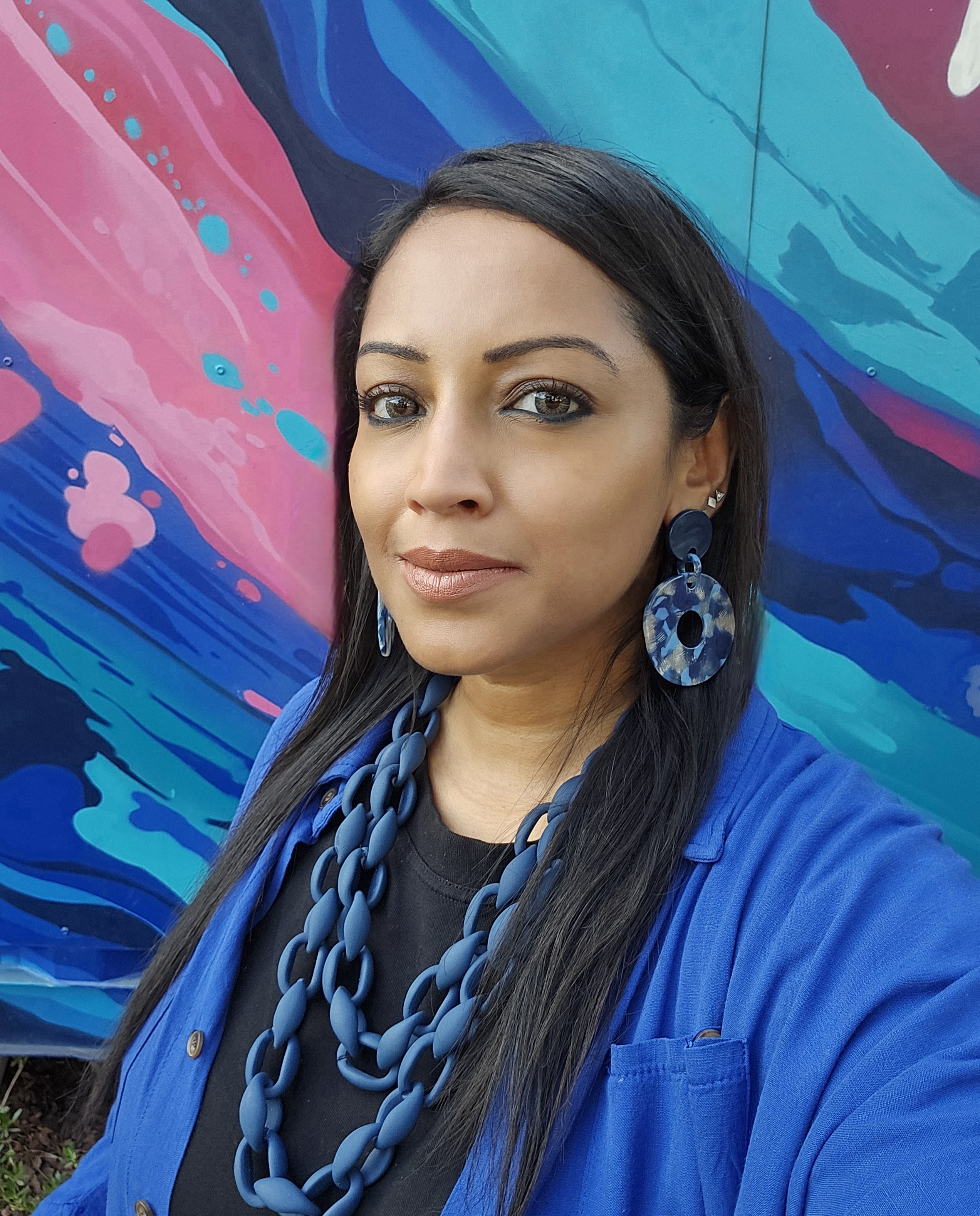 Tanisha Raffiuddin portrait against colourful backdrop