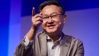 Shuhei Yoshida speaks on a conference stage.