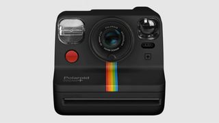 A black Polaroid Plus with its rainbow mark on it.
