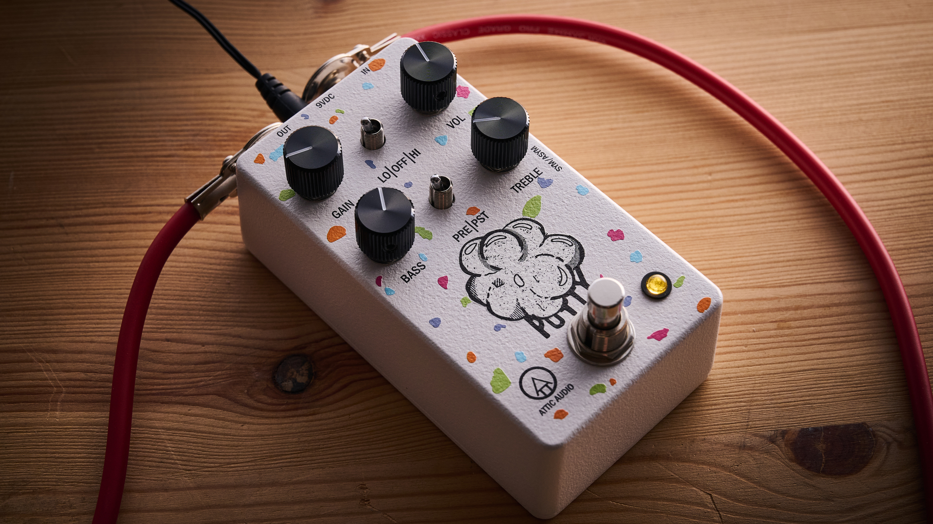 An Attic Audio Putty Saturation Preamp pedal on a wooden floor