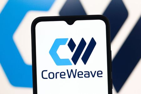 The CoreWeave logo is seen displayed on a smartphone screen