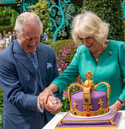 The King and Queen cutting a crown shaped cake