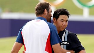 Tom Kim and Scottie Scheffler embrace after the final round of men's Olympic golf at Paris 2024