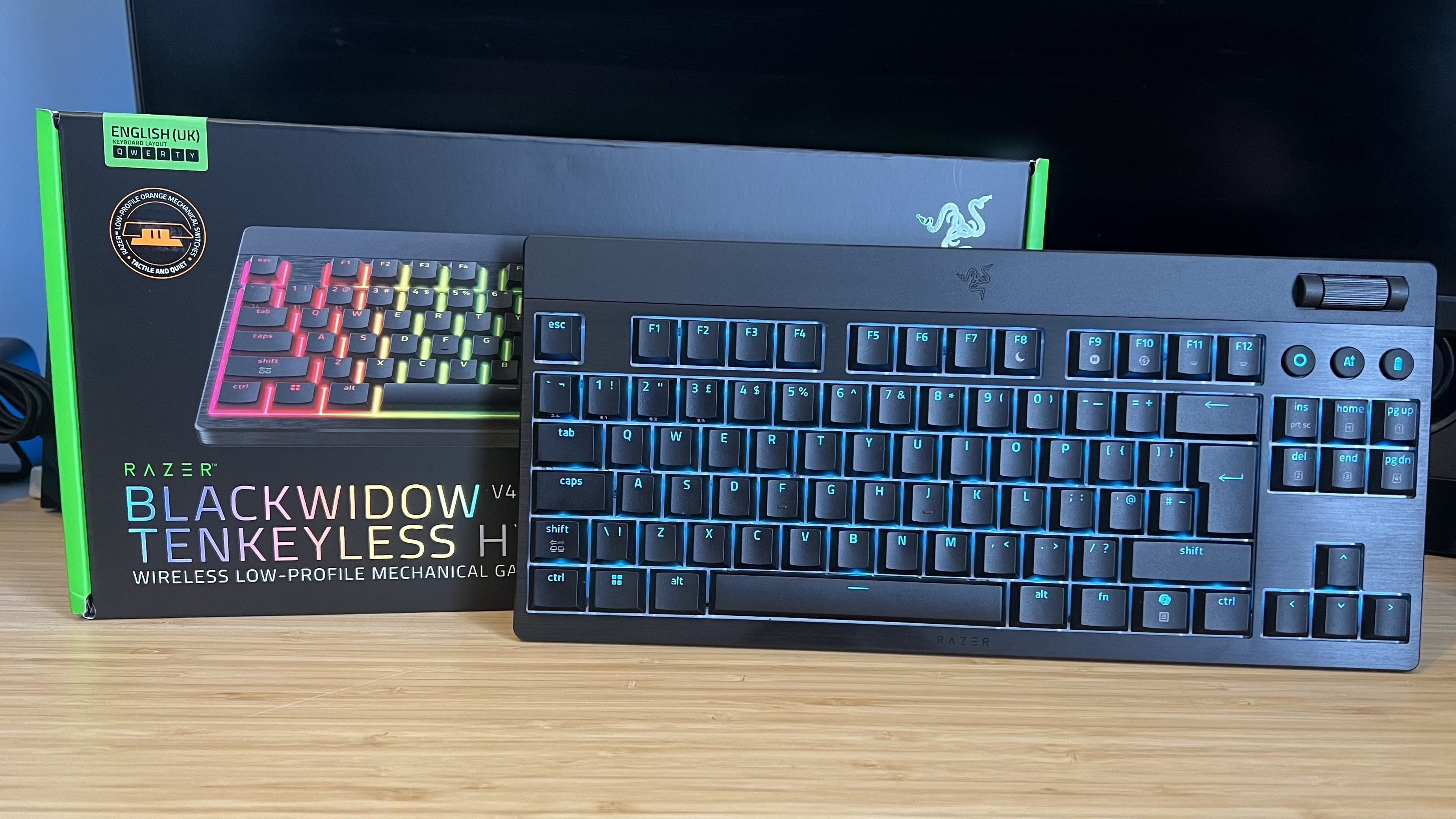 Razer Blackwidow V4 Low Profile gaming keyboard with packaging on a wooden desk