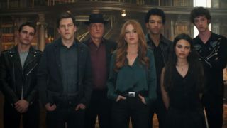 From left to right: Dave Franco, Jesse Eisenberg, Woody Harrelson, Isla Fisher, Justice Smith, Ariana Greenblatt and Dominic Sessa standing as a group in Now You See Me 3. 
