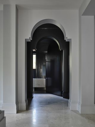 grand arched doorway into a black room