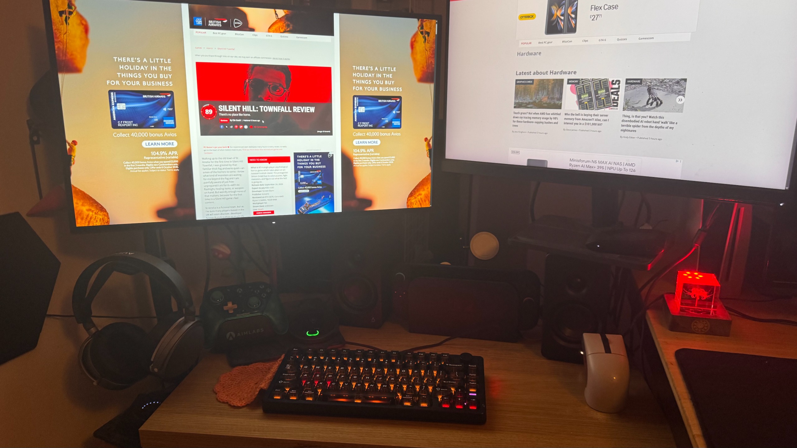 James Bentley's home setup, showing two monitors, a keyboard, a controller, a mouse, headphones, a Switch 2, and a red Naraka Bladepoint light