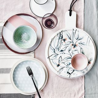 dining table with pastel plates and bowls