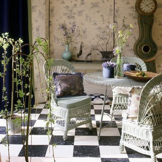 Potted plants with chairs and black white tiles