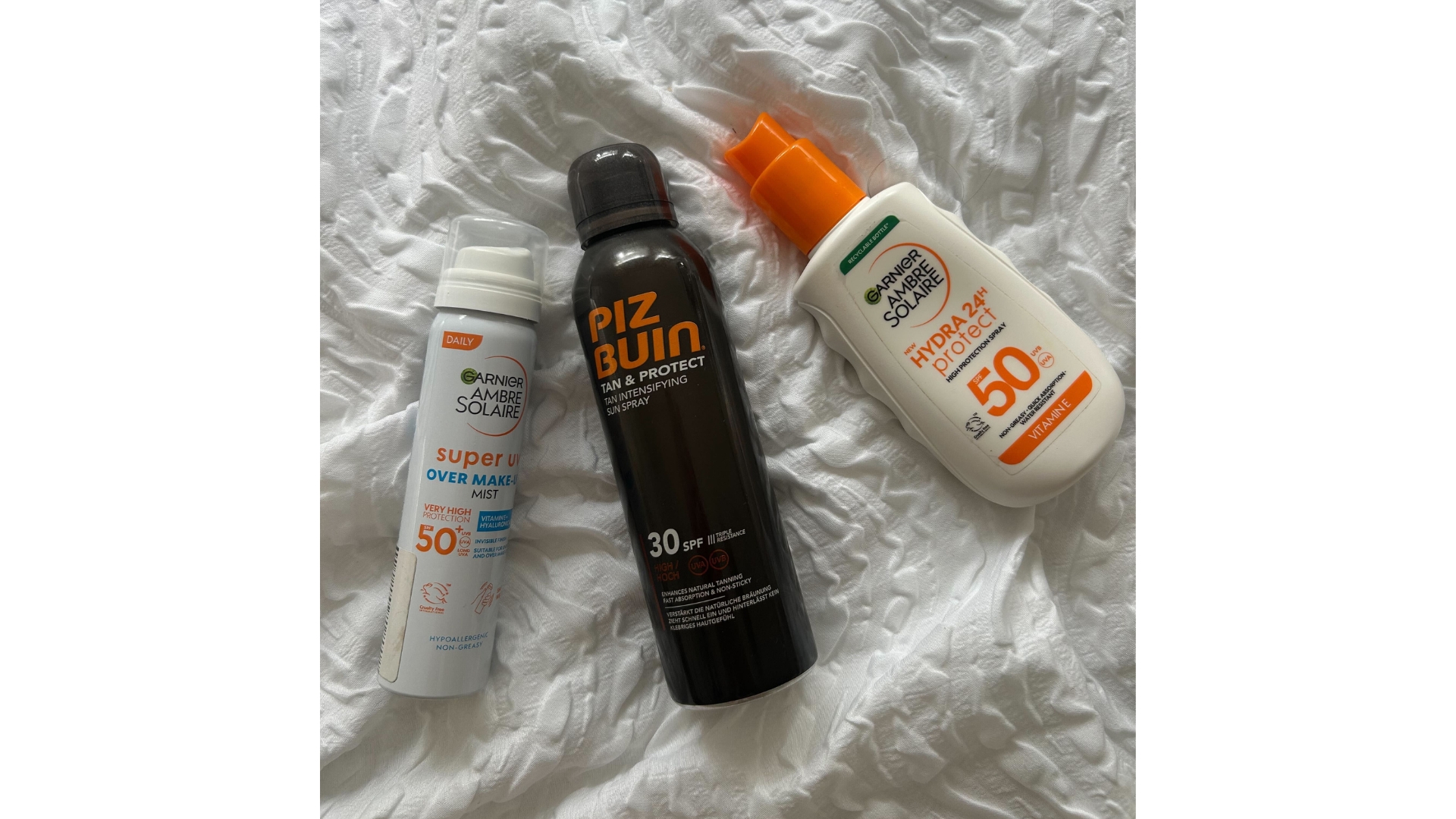 Image of the three suncreams with deals on, including Garnier face mist, Piz Buin SPF 30 and Garnier SPF50 suncream