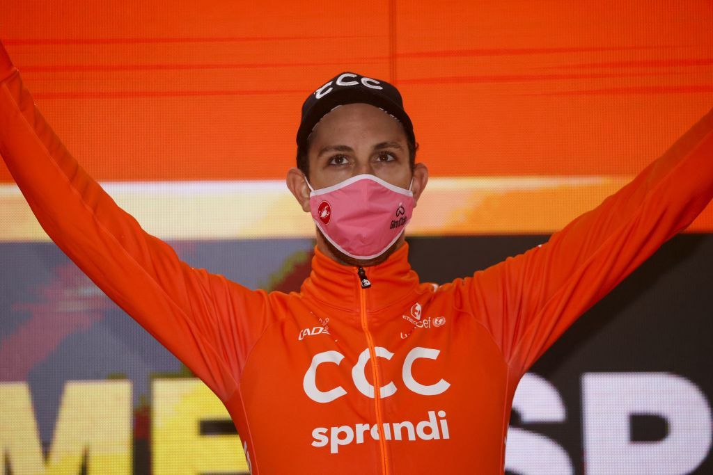 Team CCC rider Czech Republics Josef Cerny celebrates on the podium after winning the 19th stage of the Giro dItalia 2020 cycling race a 258kilometer route between Morbegno and Asti on October 23 2020 Heavy rain has interrupted on October 23 2020 the 19th stage of the Giro dItalia following protests by the riders in the face of difficult weather conditions Todays stage was planned to be a flat 258km ride between Morbegno and Asti but was cut back 100km after riders revolted when faced with pelting rain in the northern region of Lombardy Photo by Luca Bettini AFP Photo by LUCA BETTINIAFP via Getty Images
