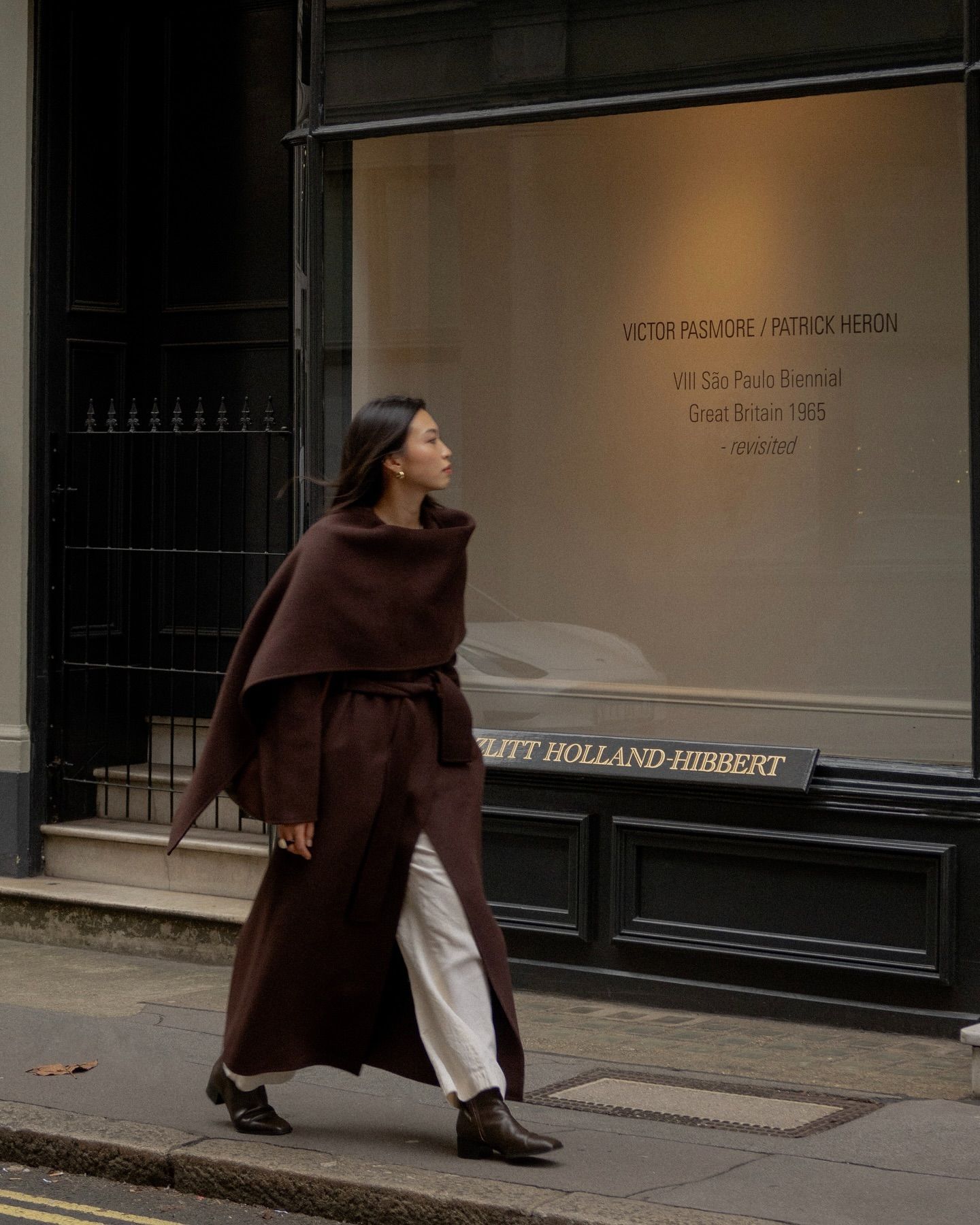 Michelle in a brown wool coat and boots