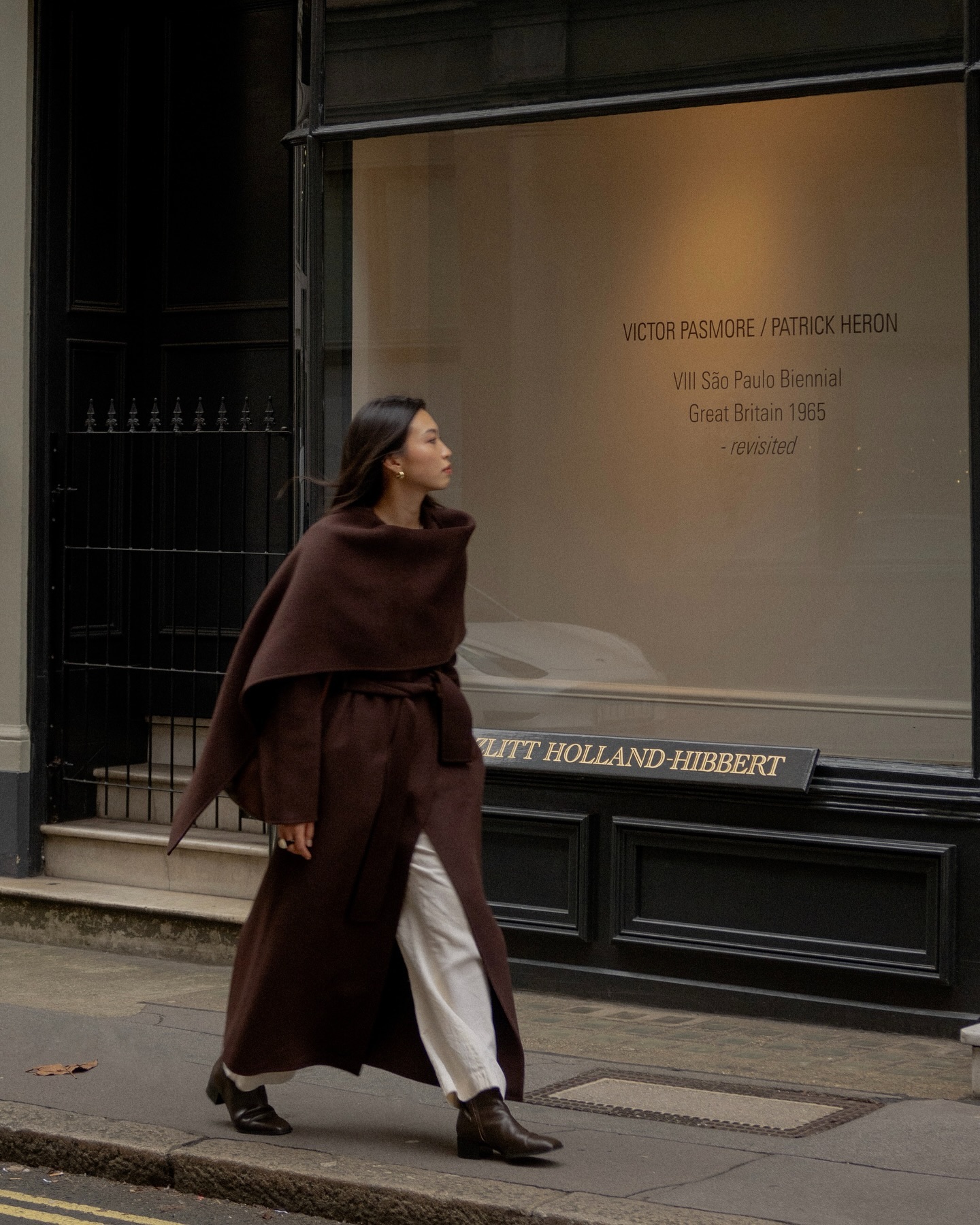 Michelle in a brown wool coat and boots