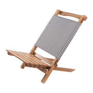 A compact wooden deckchair with slatted seat and striped material back