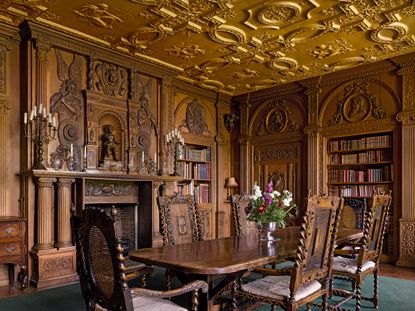 Fig 1: The library of the early 1900s, with Flemish relief carving in the panelling, was the dining room in the later 20th century. Longstowe Hall, Cambridgeshire, photographed by Will Pryce for Country Life. ©Country Life