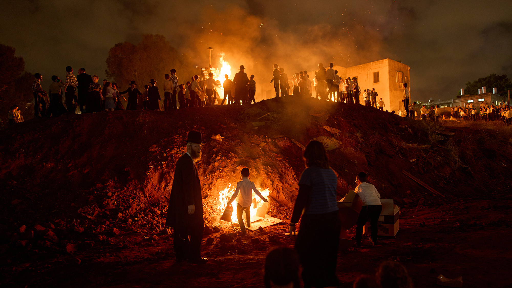 Ultra-Orthodox Jews dance around a bonfire during Lag BaOmer, a Jewish holiday of communal celebrations, in Bnei Brak, Israel