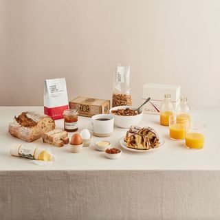 A selection of breakfast foods laid out on a linen table cloth