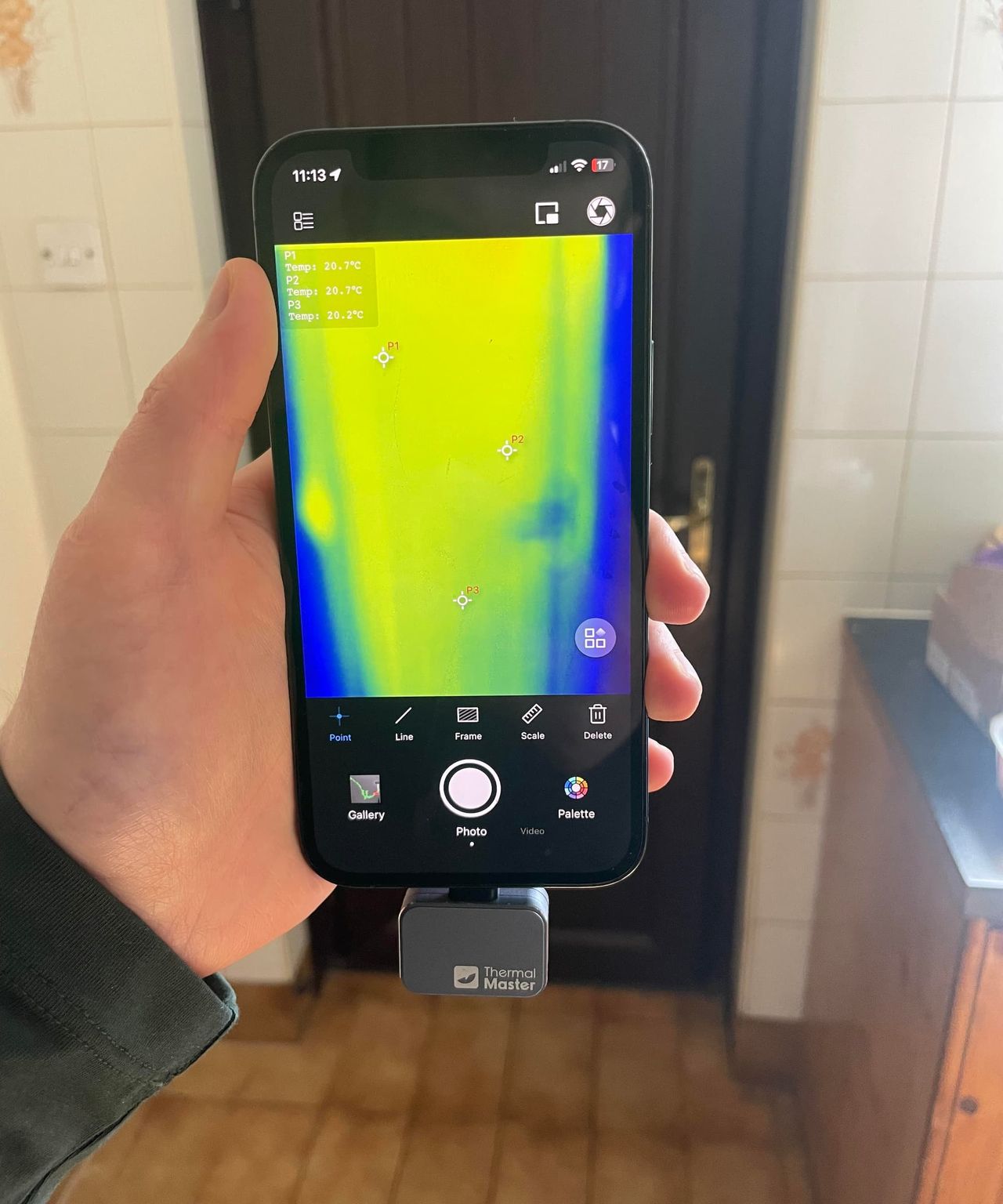 The back door of a house shown through the lens of a thermal camera