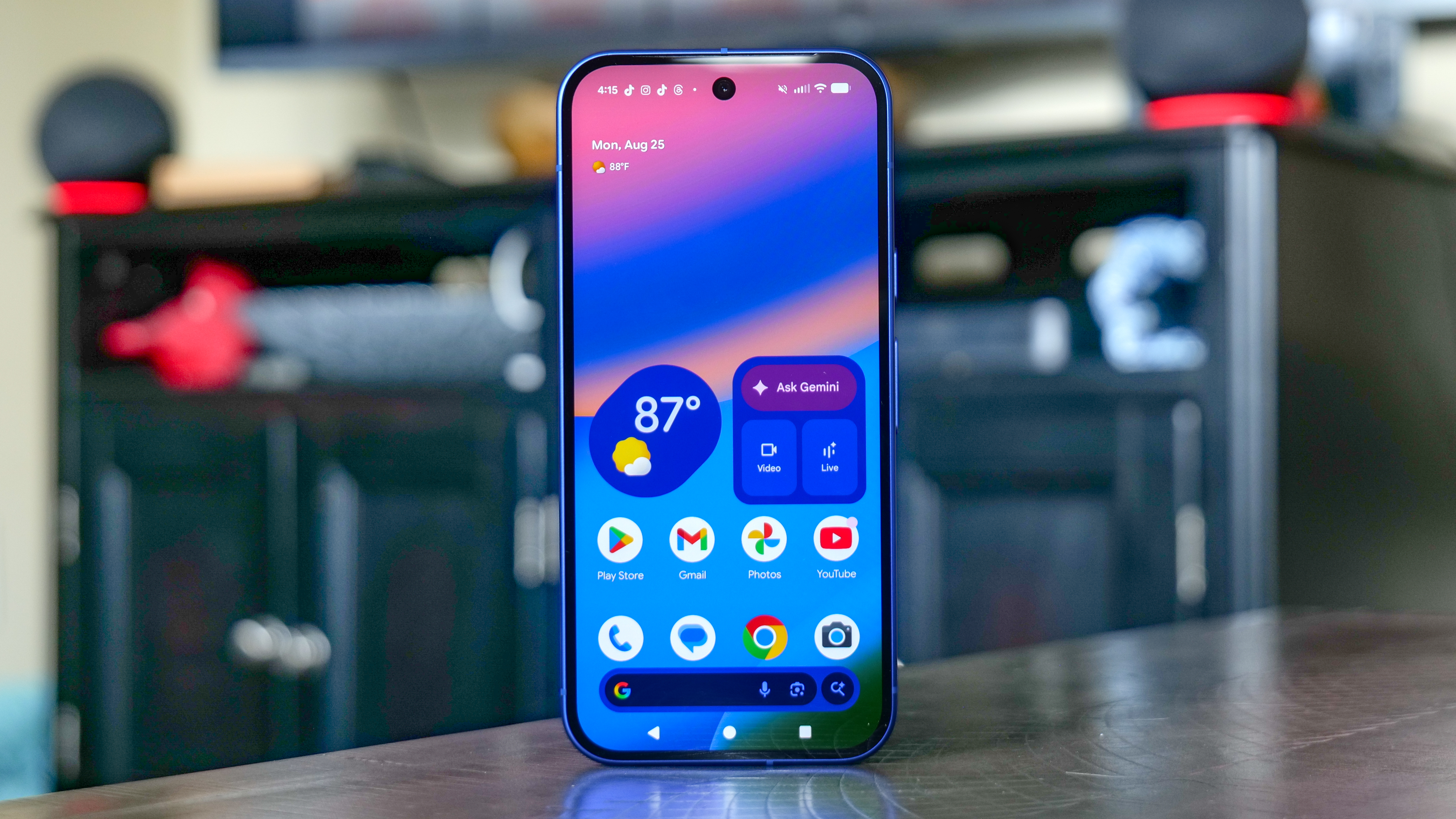 Google Pixel 10 on top of table with home screen.