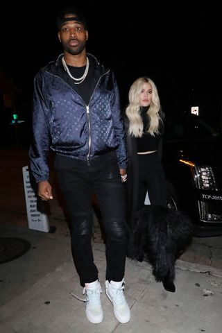 Tristan Thompson and Khloe Kardashian holding hands in 2019