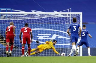 Liverpool keeper Alisson Becker, centre, saves a penalty from Chelsea'sJorginho